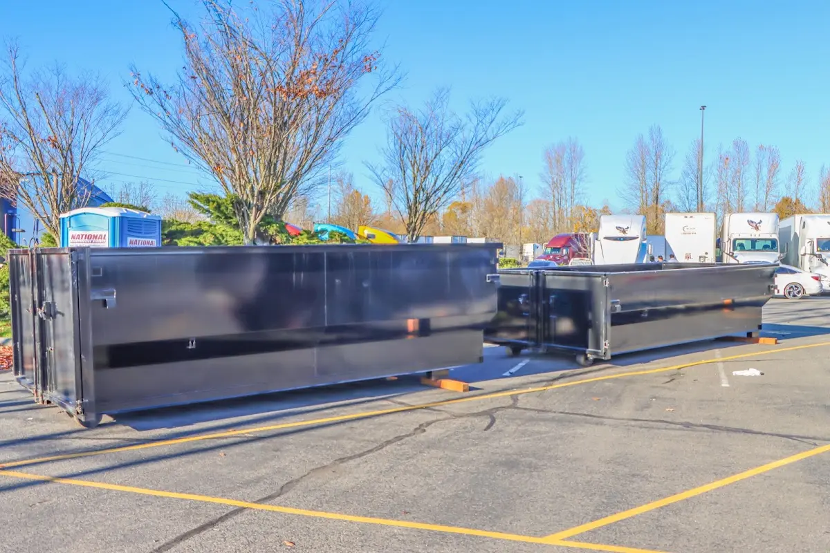 Professional dumpster rental service with roll-off container on residential driveway in West Hazleton